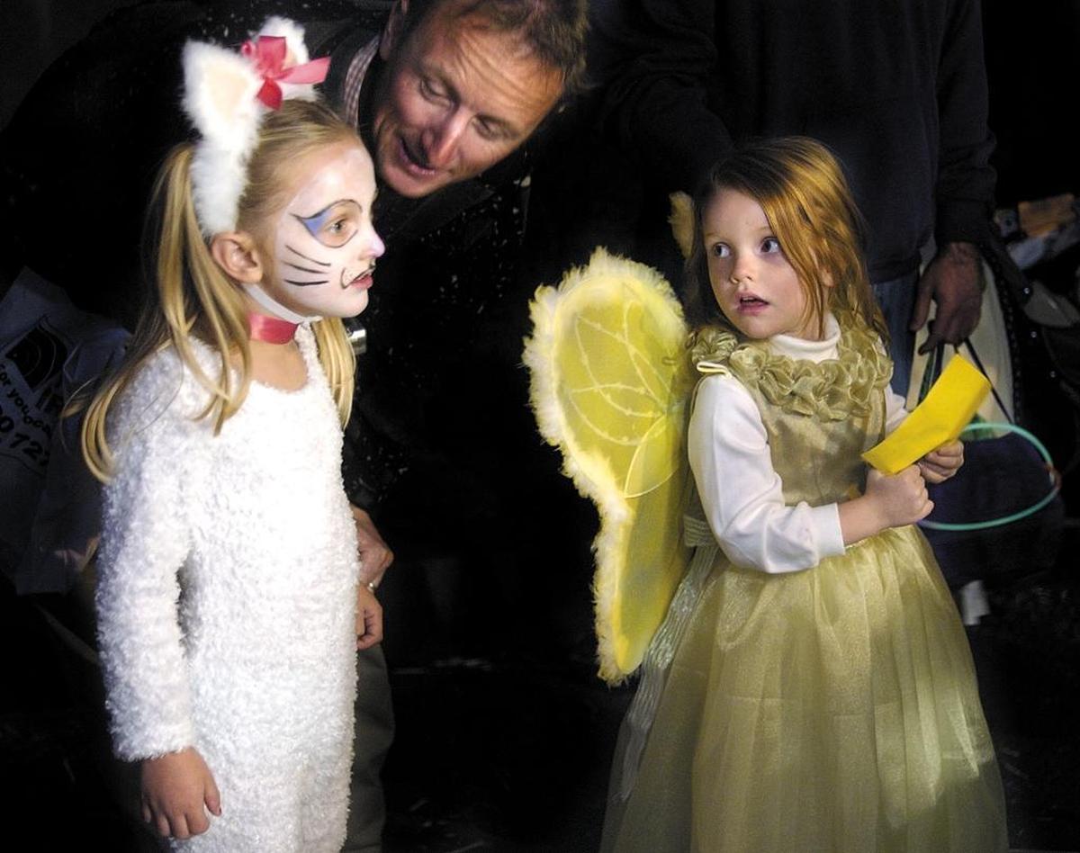 Charlie Perje gives his daughter Jessica, 4, some words of advice as Hannah Kelsh, 4, looks on before they go out on stage for the costume contest during the Downtown SLO Farmers’ Market in San Luis Obispo.