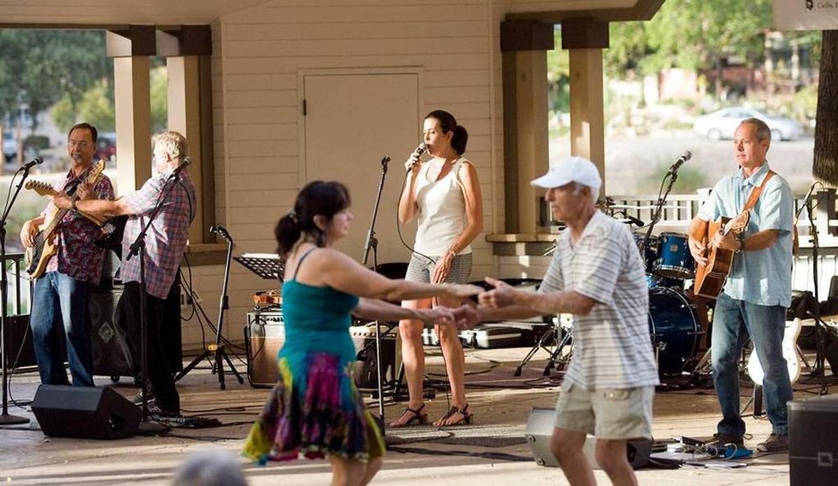 The Martin Paris Band’s lead vocalist Debby White belts out tunes while Penny Osburn, of Paso Robles and Paul Leuteritz, of Santa Margarita dance in front of the band during the Saturday in the Park summer concert series in Atascadero in 2014.