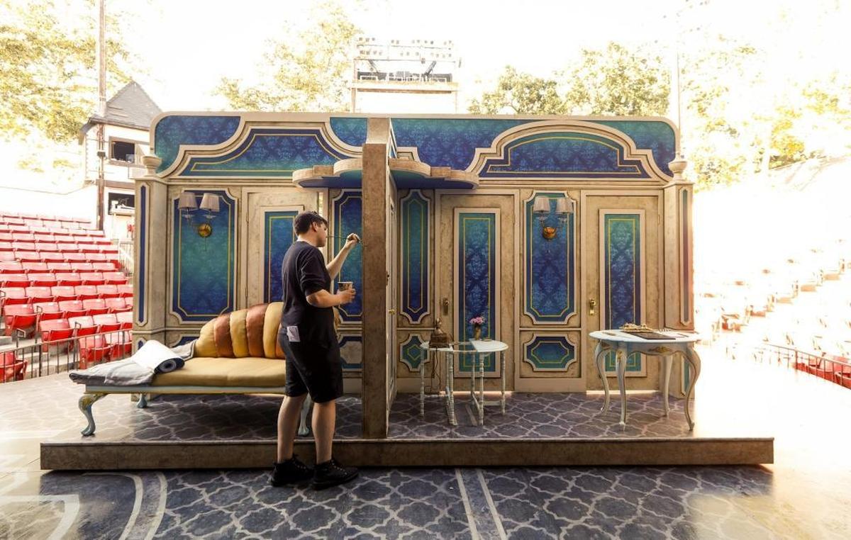 A crew member puts the finishing touches on a set piece for PCPA-Pacific Conservatory’s production of “Lend Me a Tenor The Musical” at Solvang Festival Theater.