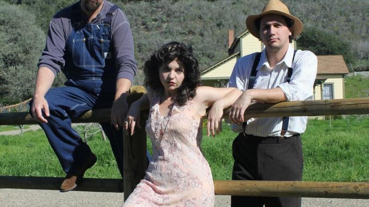 George (Tyler Lopez, left) and Lennie (Matthew Hanson, right) encounter trouble in the form of Curley’s wife (Kristie Lopez, center) in Wine Country Theatre’s production of “Of Mice and Men,” playing through March 20 in Paso Robles.