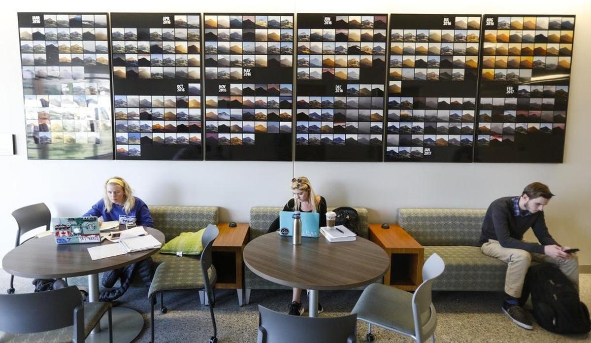 Kayla Foyt, Julia Freet and Cole Gillespie study beneath a display featuring 365 photos from Cal Poly professor Brian P. Lawler’s Bishop Peak Portrait Project. The display was installed in summer 2017 on the third floor of Cal Poly’s Baker Center for Science and Mathematics.
