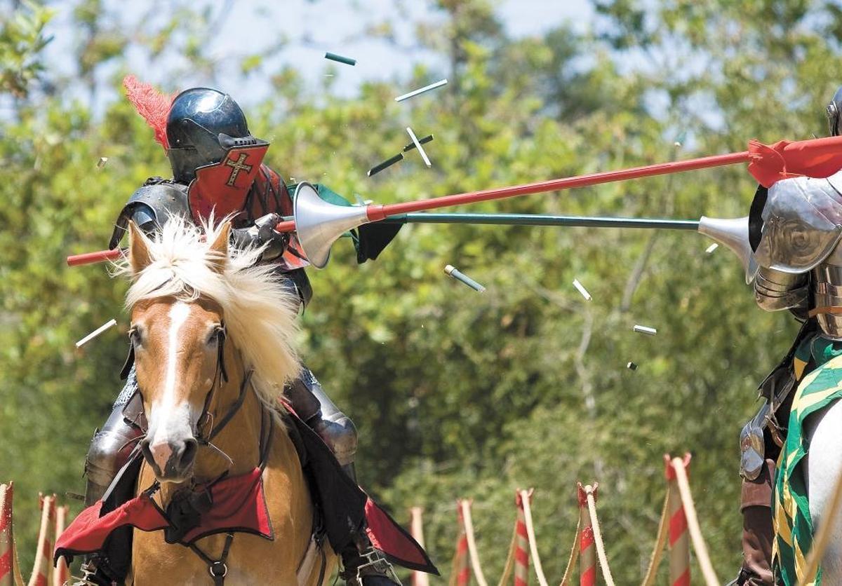 Jeff Sanders, left, is struck by William Hamersky during the Central Coast Renaissance Festival in 2011. The festival returns to Laguna Lake Park in San Luis Obispo on Saturday and Sunday.