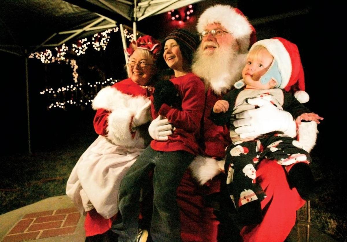 Santa Claus, also known as Charley Carlin of Atascadero, and Mrs. Claus, Lee Marx of Paso Robles, hold Joseph, 6 and Dillon, 11 months, for a photo in Paso Robles. The Vine Street Victorian Showcase returns to Paso Robles on Dec. 9.