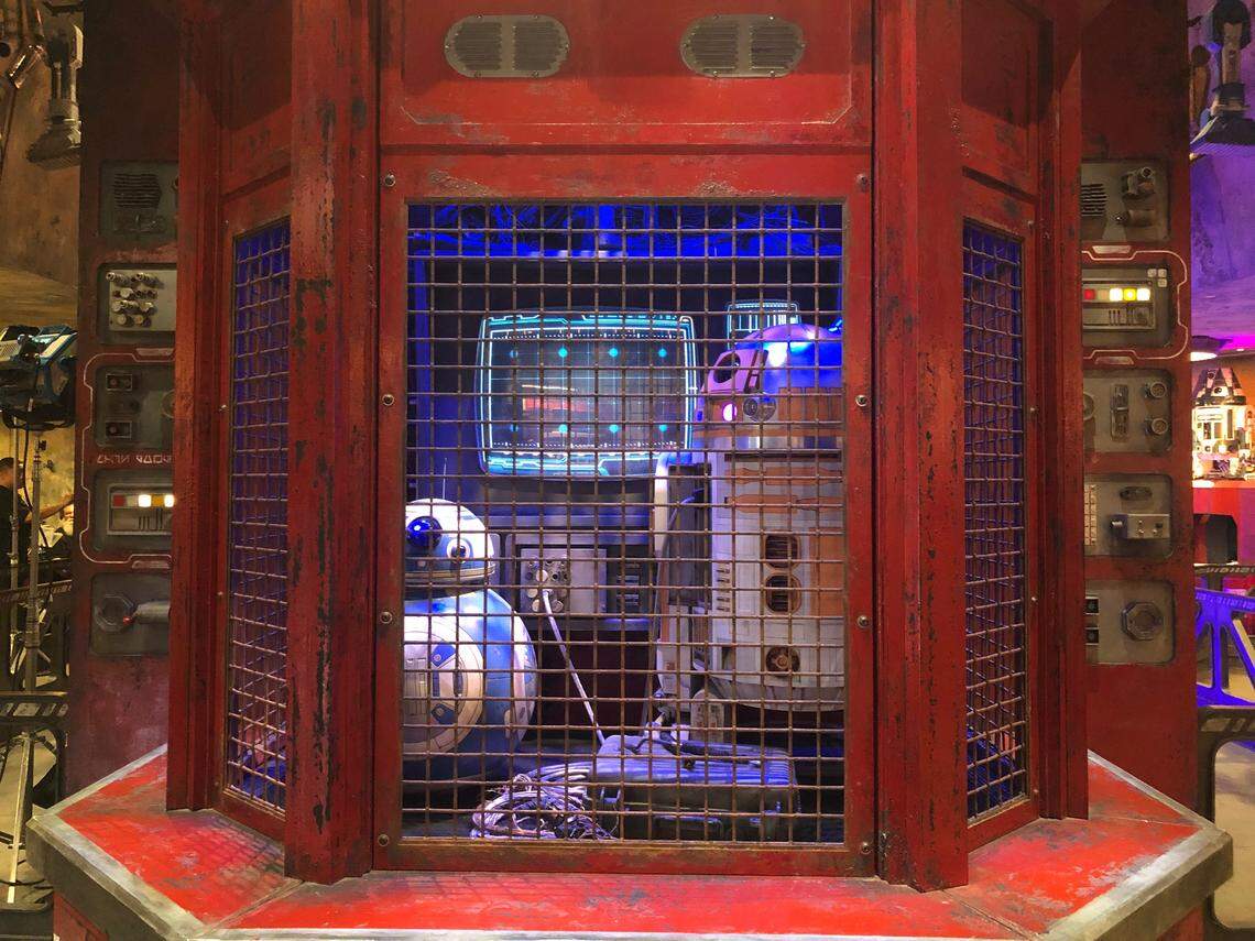 In the Droid Depot at Disneyland’s Star Wars: Galaxy’s Edge, visitors can build their own droids, or pick up any other droid themed goods. They can also take in the various beeps and whirrs of the full-size droids trapped behind the cash register.