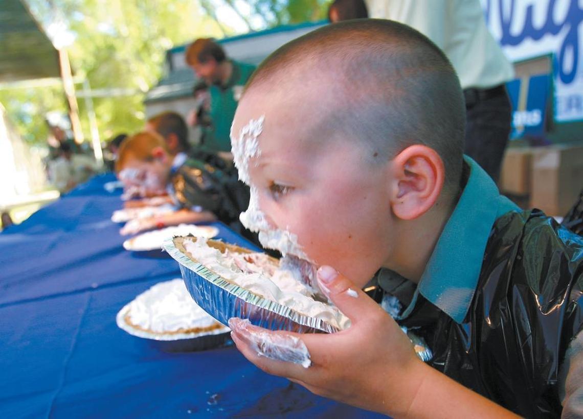 Nicholas Starbuck, 5, tries to keep up with the older kids in a 12-and-under pie-eating contest at the California Mid-State Fair in Paso Robles.