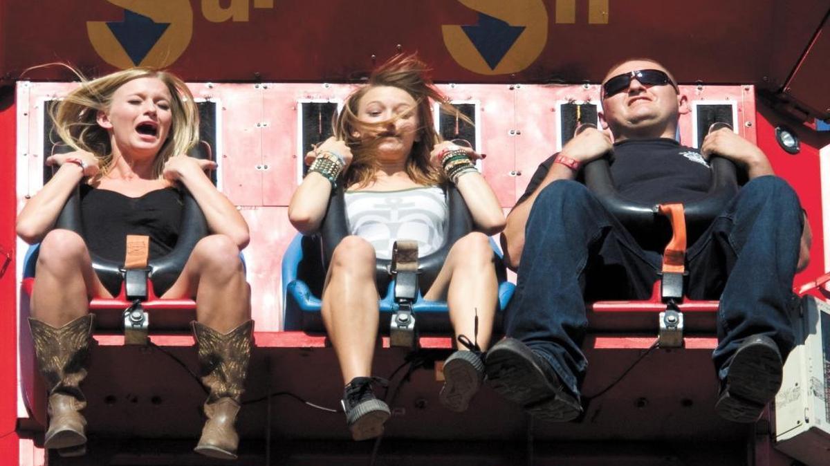 Kali Pengilly, sister Ariauna and cousin Cody Reyes react as the Super Shot begins to fall to earth at the California Mid-State Fair in Paso Robles in 2013. New, cheaper carnival rides are coming to the fair this summer.