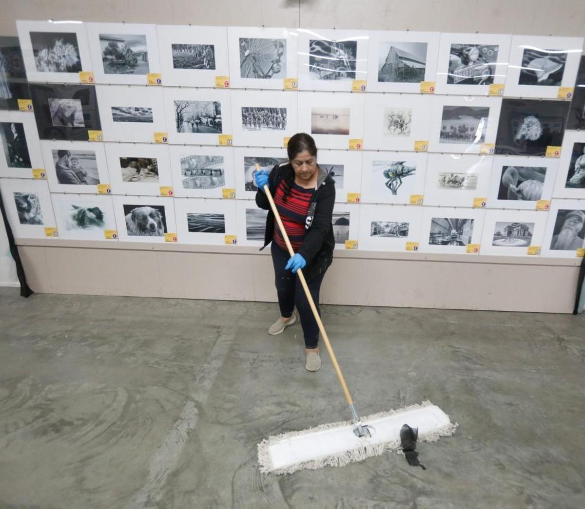Rosalinda (declined to give last name) sweeps the photography exhibit hall as the Mid-State Fair prepared for opening day in 2017.