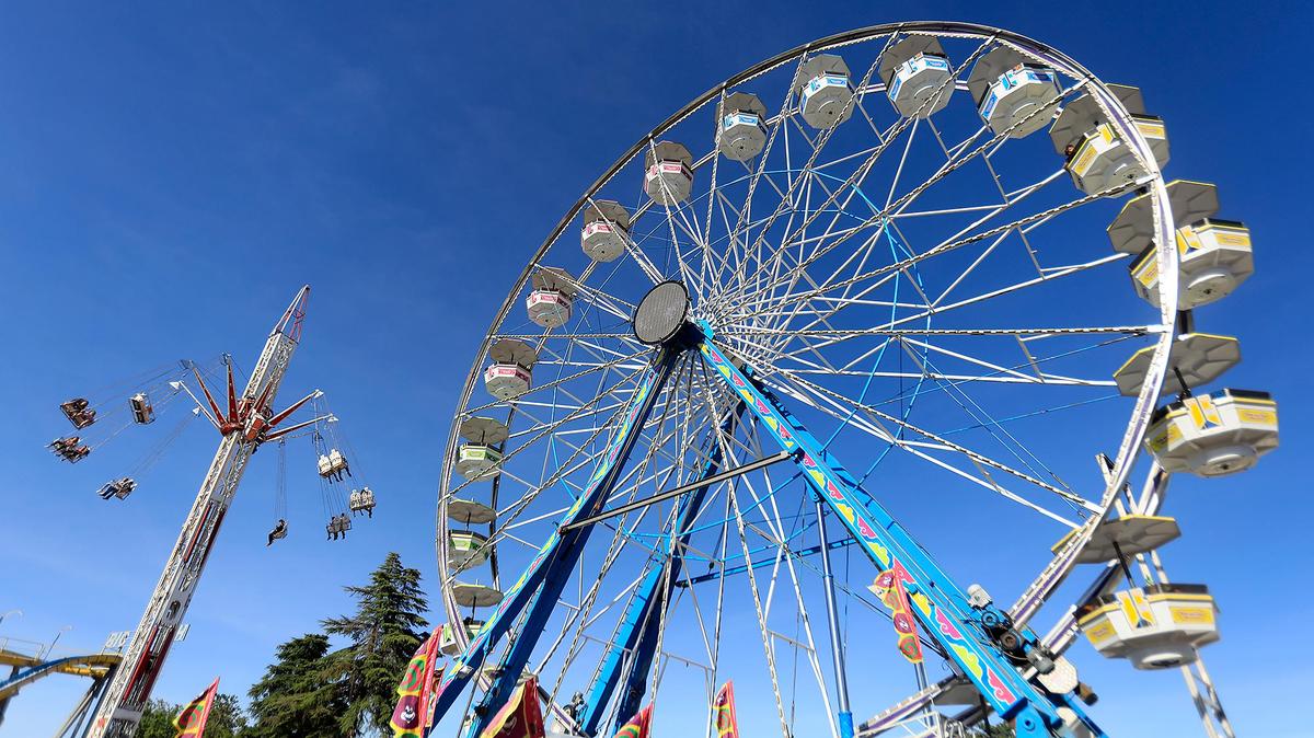 Fairgoers enjoy free carnival rides on opening day of the California Mid-State Fair in Paso Robles, Wednesday, July 17, 2019. The Star Tower and the Big Wheel are the tallest rides at the fairgrounds.
