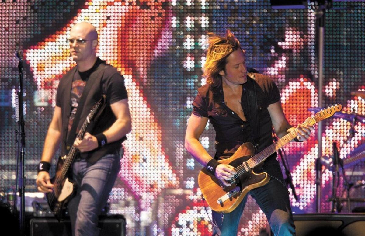 Keith Urban, right, performs at the California Mid-State Fair in Paso Robles in 2010. The country star will return to the Paso Robles Event Center on July 26.