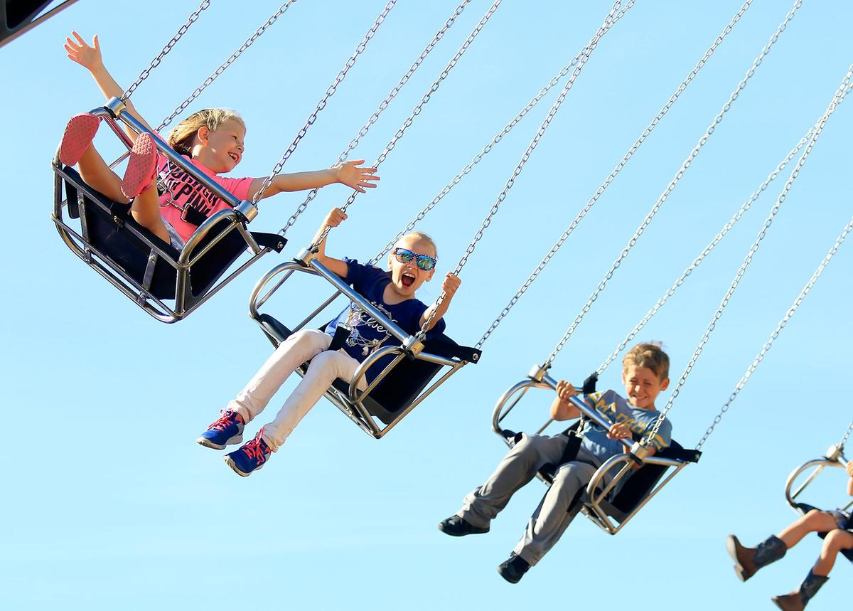 Riders on the Happy Swings enjoy a breezy ride partly controlled by centripetal force.