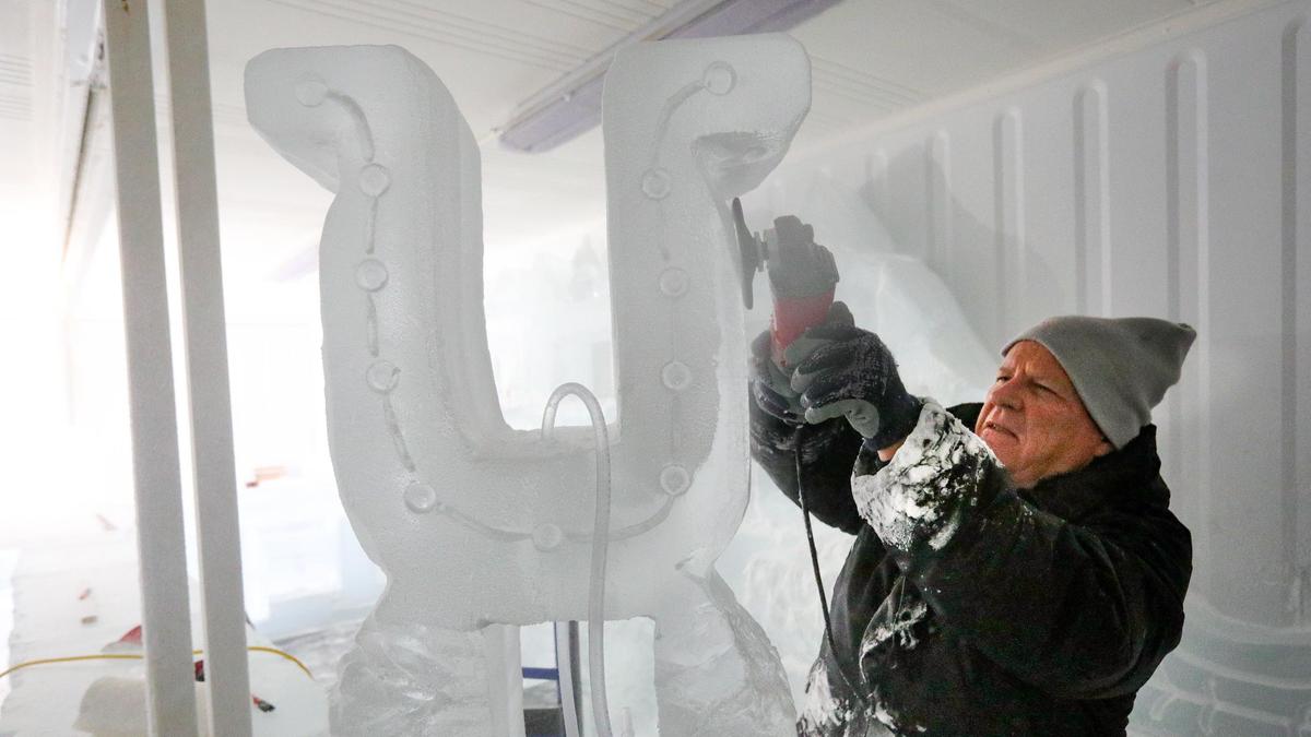 Ice sculptor David Faber makes a ice horseshoe that drinks can be poured through in the first-ever ice saloon at the California Mid-State Fair in Paso Robles. The refrigerated bar room has 78 blocks of ice, weighing 400 pounds each. The sculptor, who competed in the 2013 ice-sculpting competition in Alaska, says this room is colder.
