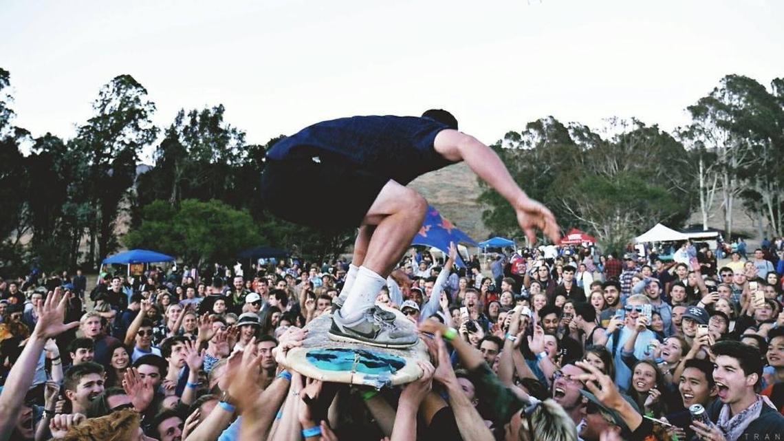 A concertgoer rides a surfboard through the crowd at Shabang. The homegrown music festival returns to Laguna Lake Park in San Luis Obispo on Saturday, May 6, 2017.