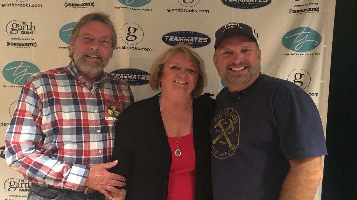 Stuart and Denise Stewart pose for a photo with country star Garth Brooks, right, backstage at Brooks’ concert Friday at The Forum in Inglewood.