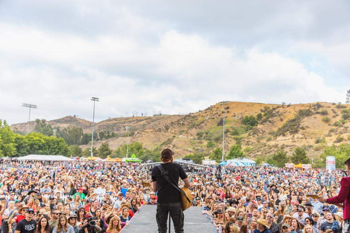 A performer plays for the crowd at the Boots & Brews Country Music Festival Santa Clarita. The festival comes to the Madonna Inn in San Luis Obispo on Sept. 29, 2018.