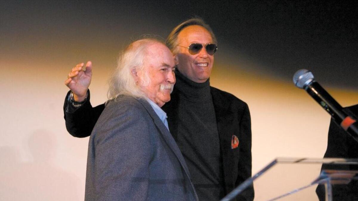 Peter Fonda, right, accepts the King Vidor Career Achievement Award from David Crosby at the San Luis Obispo International Film Festival in 2008.
