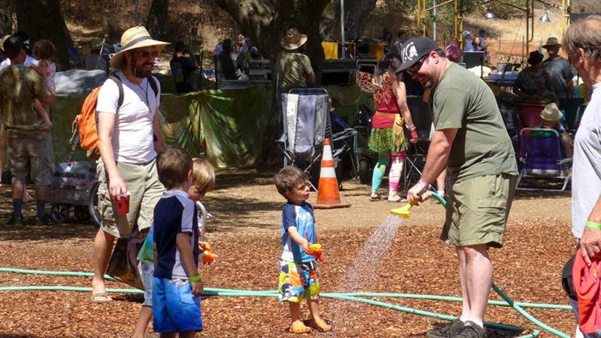 Dads and kids hang out at Live Oak Music Festival in 2013. The outdoor music festival returns to northern Santa Barbara County on Friday, Saturday and Sunday.