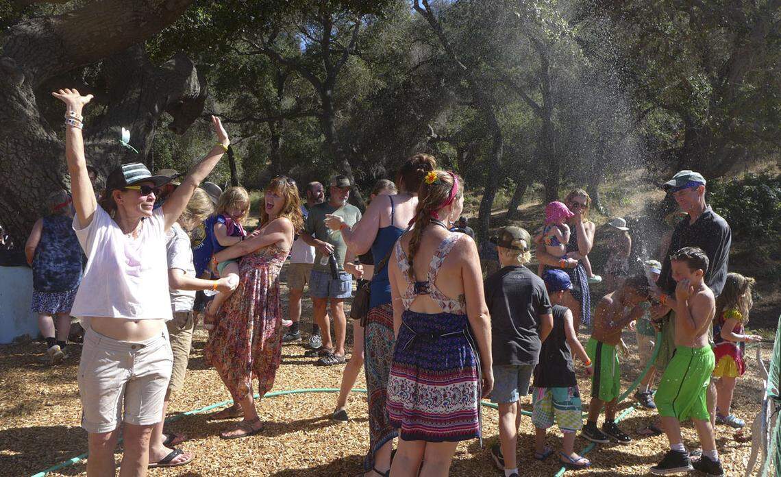 Festivalgoers play in the water at Live Oak Music Festival in 2017. The festival is moving from northern Santa Barbara County to San Luis Obispo in 2019.