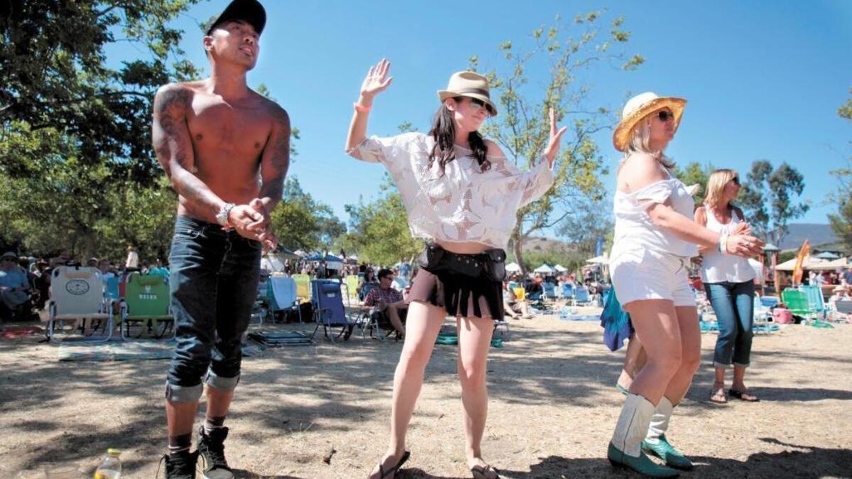 Arsen Vasquez of Los Angeles and Lauren Kincheloe of New York dance to the music of Sister Sparrow & the Dirty Birds at Seven Sisters Craft Beer and Music Fest in July 2013 at El Chorro Regional Park and Campground in San Luis Obispo. The festival, which was co-produced by HarvestMoon Inc. and Tap It Brewing Co., will not return this summer.