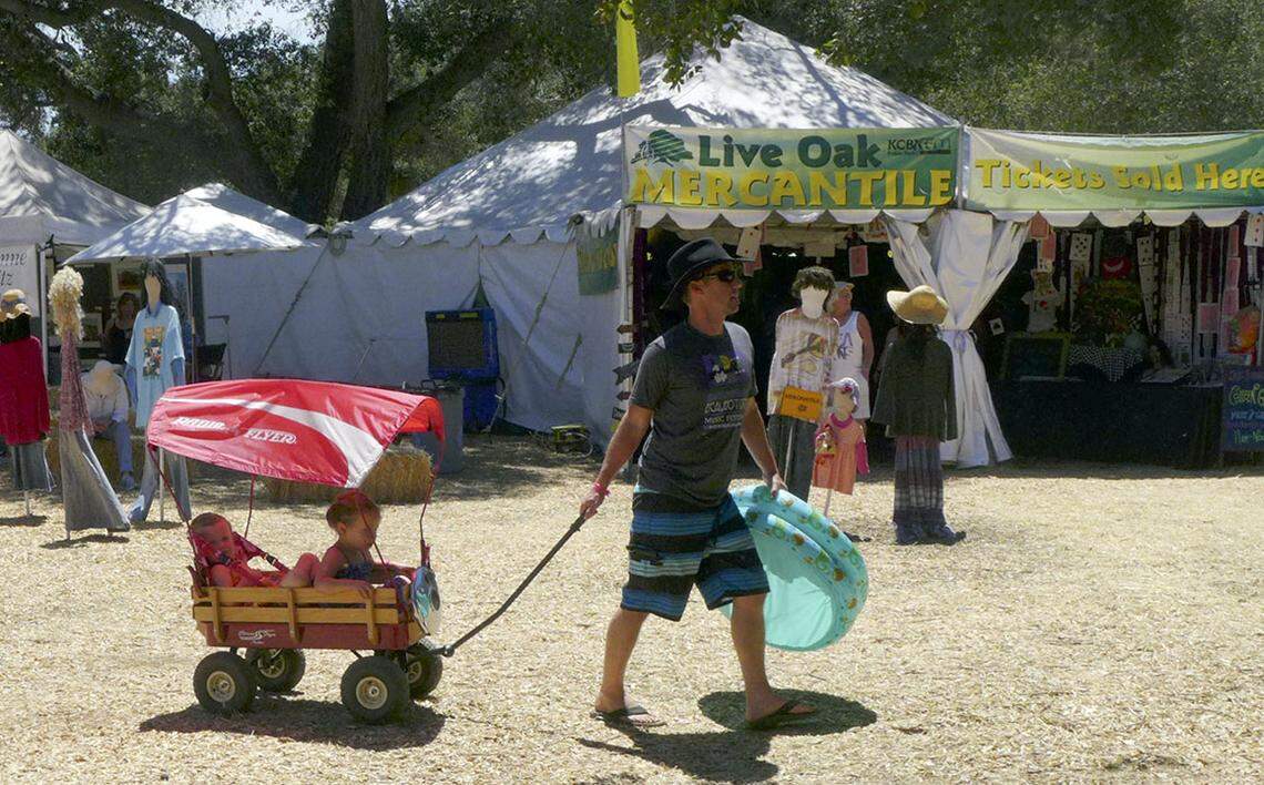 A dad pulls two small children in a wagon at Live Oak Music Festival in 2016. The festival returns to northern Santa Barbara County for Father's Day weekend in 2018.
