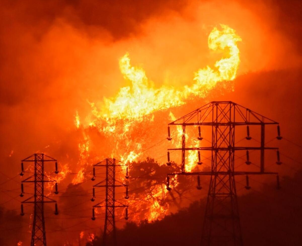 Flames burn near power lines in Sycamore Canyon near West Mountain Drive in Montecito on Dec. 16, 2017, during the Thomas Fire, the largest wildfire in modern California history.