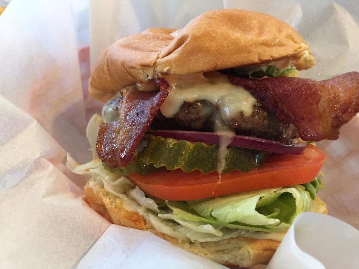 The Luna Burger features bacon, jack cheese, lettuce, tomato, pickles, onions, a healthy portion of avocado, as well as mayo and thousand island dressing.
