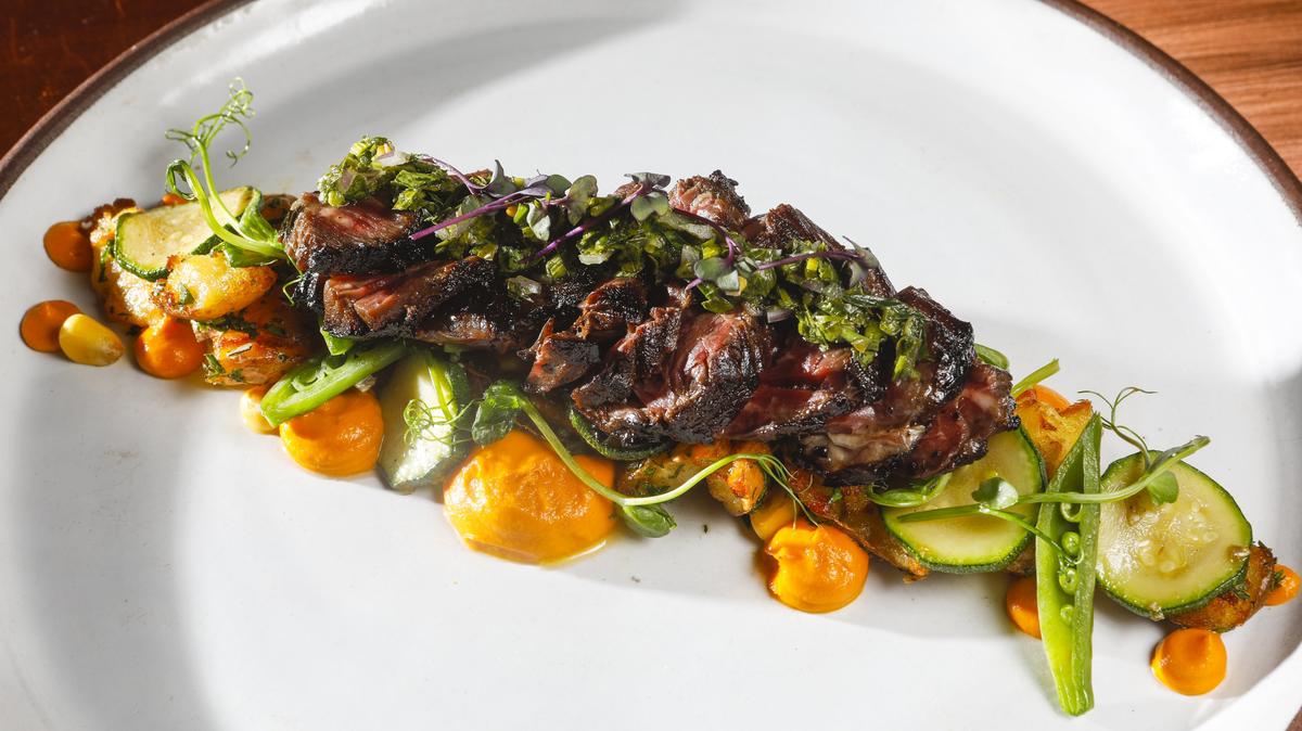 At Blue Heron restaurant in Baywood Park, pan-seared hanger Steak comes with crispy fingerling potatoes, glazed farm vegetables, cumin carrot purée and salsa verde.