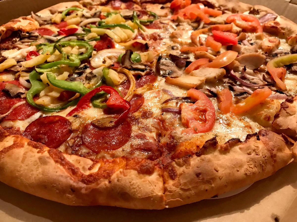 A half-and-half combo from Woodstock’s Pizza in San Luis Obispo features The Bomb on one side and the Garlic Bird on the other.