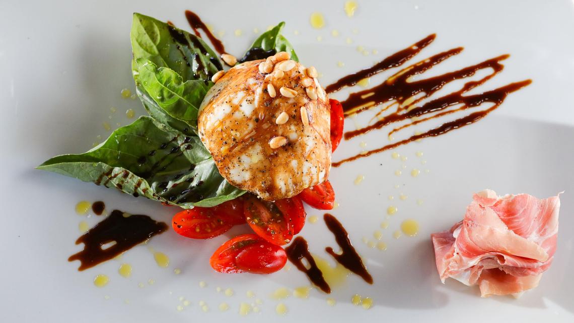 The burrata plate at Niner Wine Estates in Paso Robles features whole burrata served with accompaniments such as tomatoes, pine nuts and basil.