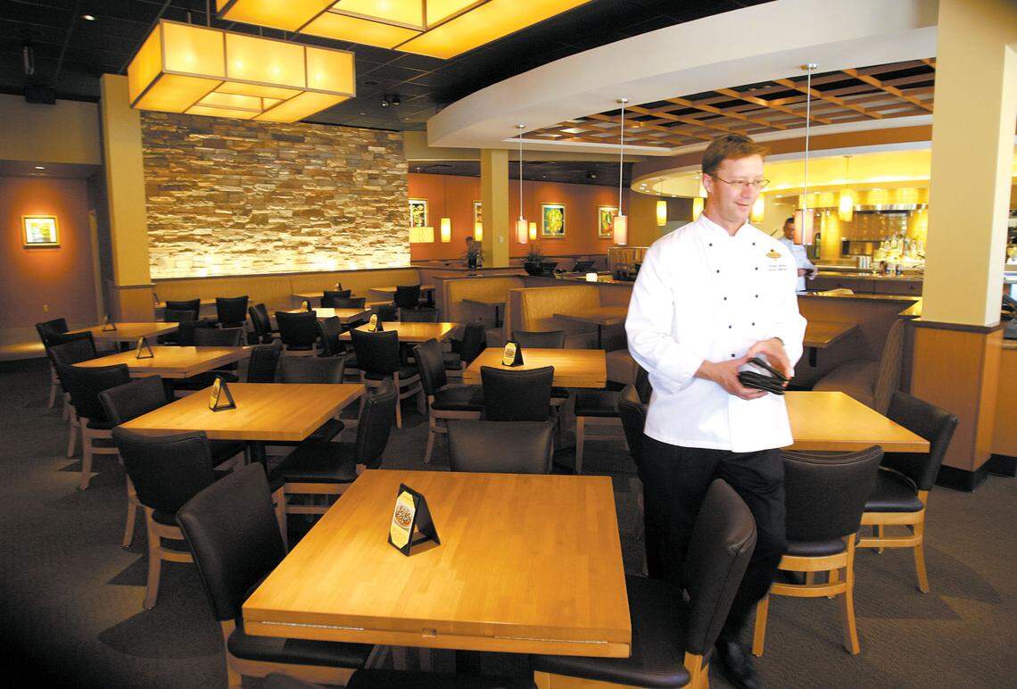 Douglas Beima puts out table cards at the California Pizza Kitchen in San Luis Obispo’s Downtown Centre before the restaurant’s opening in 2006. The restaurant moved into a space formerly occupied by Fresh Choice.