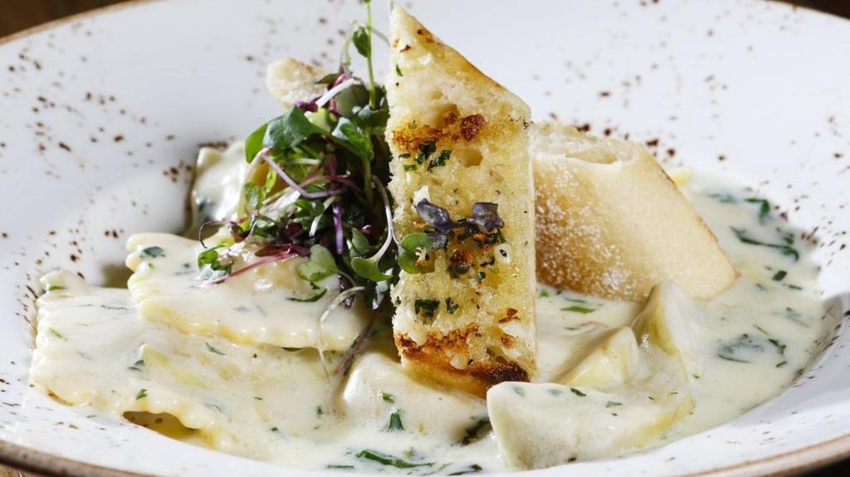 Italian sausage ravioli is served with artichoke, parsley, parmesan cheese and HammerSky Vineyards white wine cream sauce at Cello Ristorante and Bar in Paso Robles.
