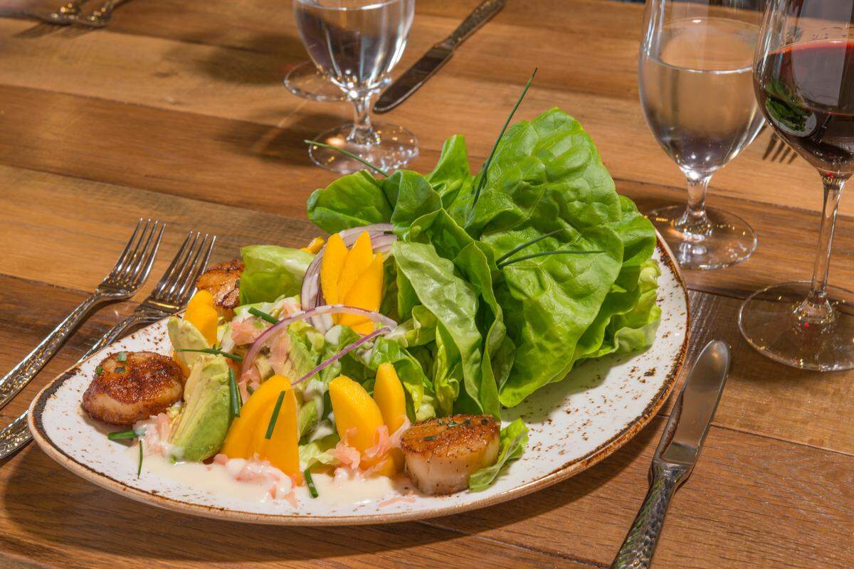 A scallop salad comes with thyme-seared scallops, butter leaf lettuce, avocado, mango and ginger at Cello Ristorante & Bar at Allegretto Vineyard Resort in Paso Robles.