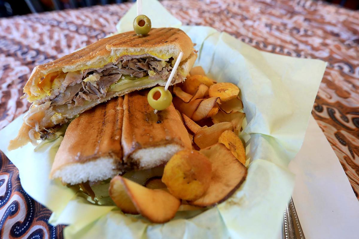 A popular menu item at Milanes Cuban Cafe in Morro Bay is the classic Cubano-Cuban sandwich, featuring marinated roasted pork, ham, Swiss cheese, sliced dill pickles and mustard pressed panini-style on Cuban bread.
