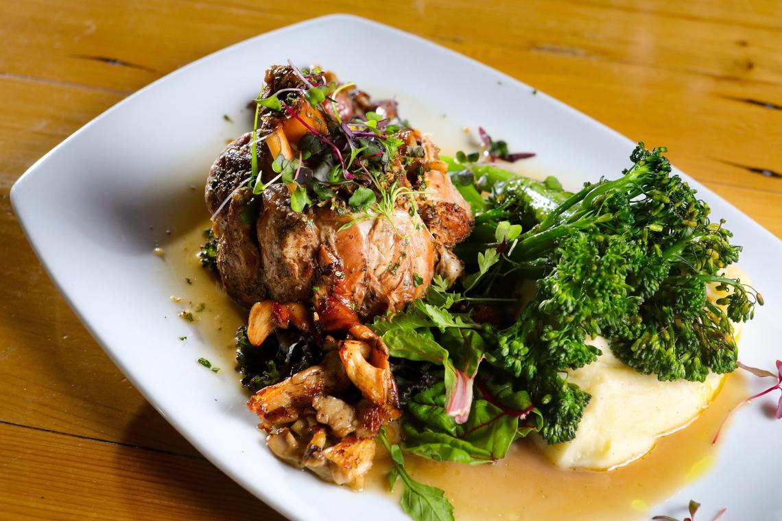 Osso buco is served with lemon olive oil mashed potatoes, broccolini, estate-grown garden greens, blistered grapes and fried cat mint at Niner Wine Estates in Paso Robles.