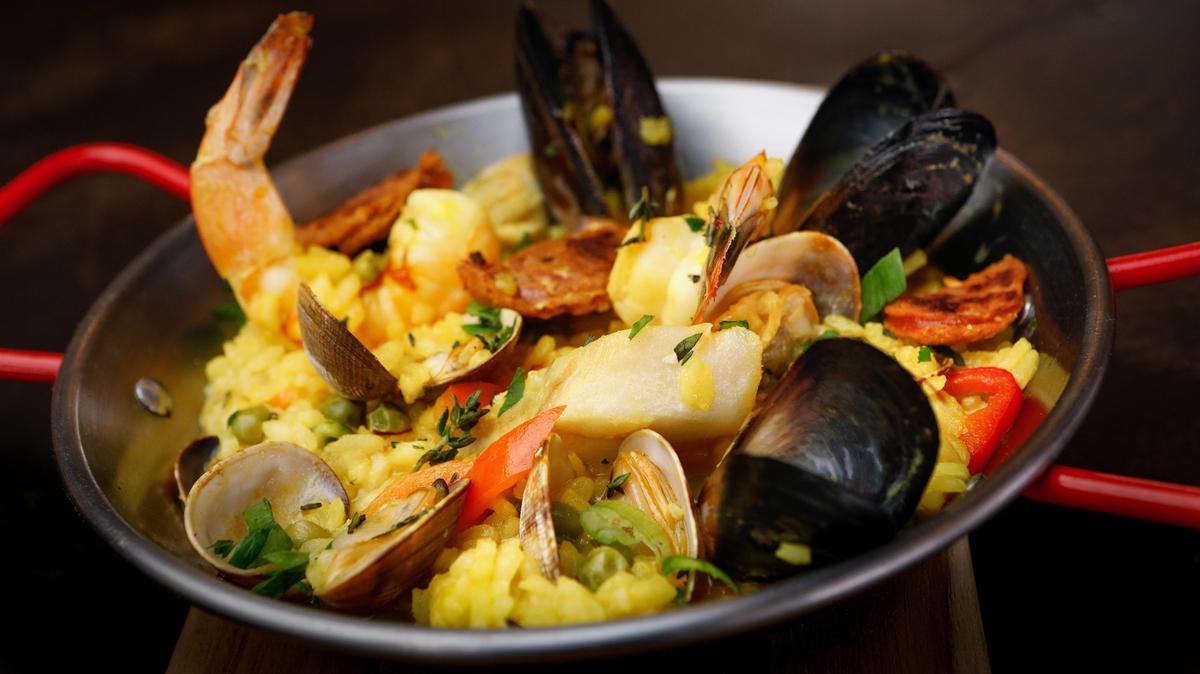 The Valencia paella at La Bodega Tapas, a Pismo Beach restaurant specializing in Spanish-style tapas, features saffron arborio rice, shrimp, clams, mussels, cod, chicken, Spanish chorizo, peas, bell peppers and herbs.