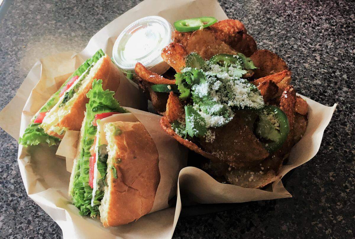 Sandwich options at Chipwrecked in Pismo Beach include the Port Margherita, left, which features provolone cheese, tomato, lettuce and basil. The restaurant also offers gourmet potato chips such as El Conquistador, right, with chili-salt seasoning, cotija cheese, cilantro and jalapeno peppers.