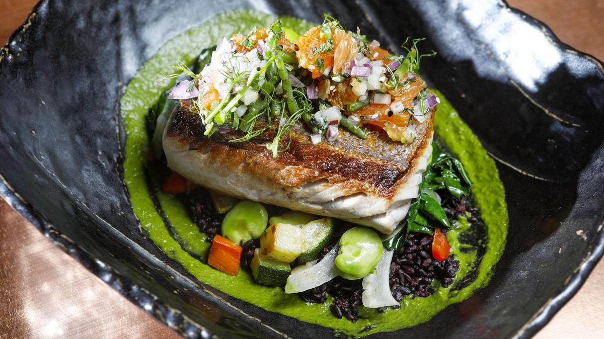 California yellowtail is served with forbidden rice, zucchini, carrot, bok choy, snap peas, cilantro chimichurri and citrus relish at Blue Heron restaurant in Baywood Park.