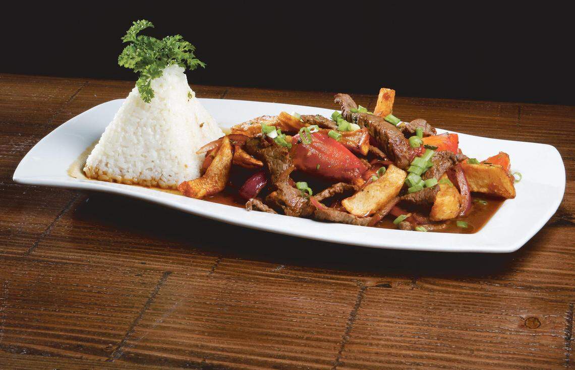 Lomo saltado at Mistura in San Luis Obispo features free-range natural top sirloin strips stirfried with organic fresh tomatoes, red onions, Peruvian spices, aji amarillo, soy sauce, potatoes and parsley served with Peruvian white rice.