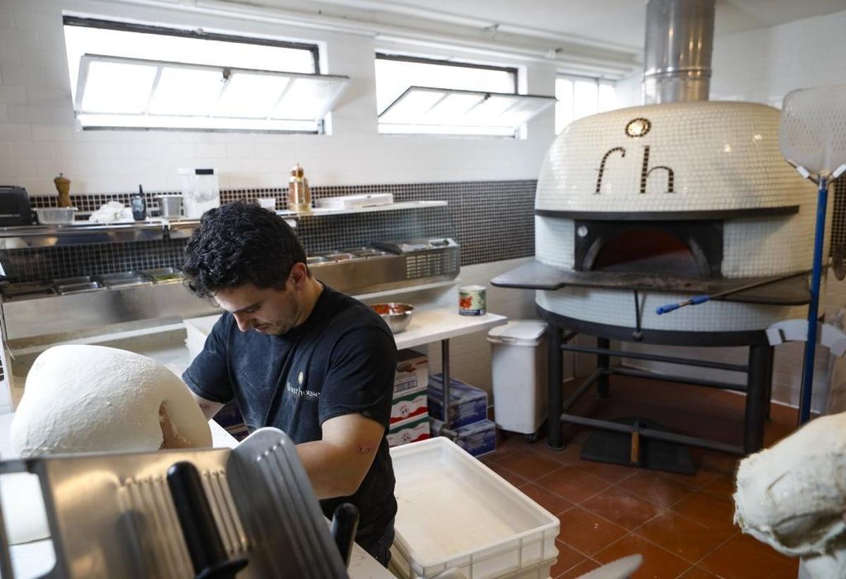 Restaurant co-owner Alberto Russo prepares to stretch pizza dough at Flour House in San Luis Obispo.