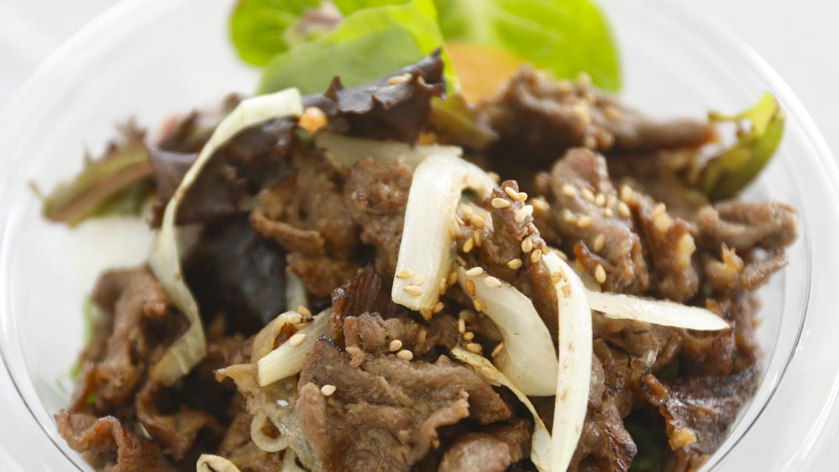 The Feed My Seoul food truck serves Korean-style barbecue such as thin-sliced sesame soy beef and onions in soy sauce, served with rice, grilled vegetables and sweet potato glass noodles.