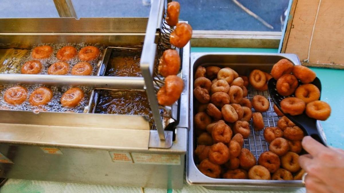 Miniature doughnuts are served at the Sugar Lips Mini Donuts booth at the San Luis Obispo farmers market.