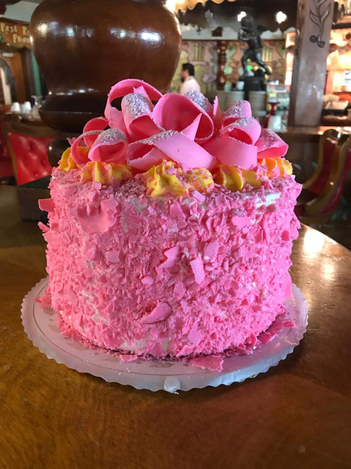 The Madonna Inn’s signature champagne cake is decorated in a pink chocolate garnish.