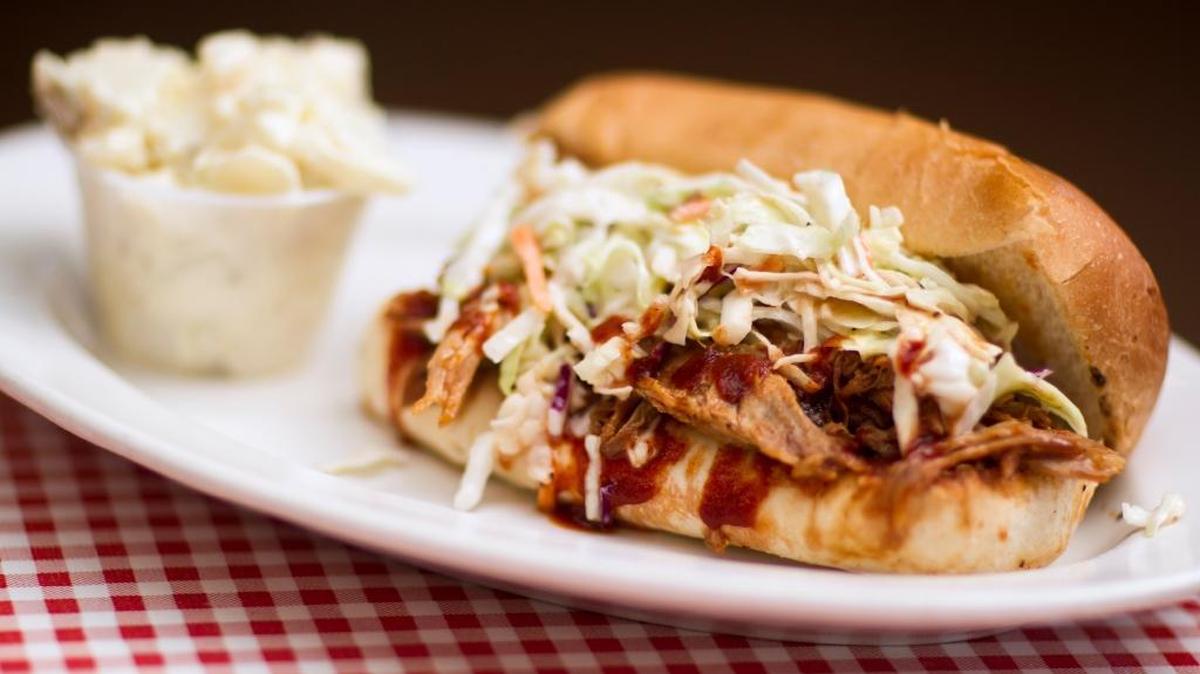A Carolina pulled pork sandwich is served with potato salad at G. Brothers Smokehouse in San Luis Obispo.