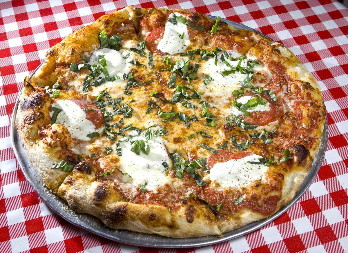 At Giuseppe’s Cucina Rustica in San Luis Obispo, the classic margherita pizza is topped with tomato, mozzarella, basil and olive oil on either thick Sicilian or thin Neopolitan crust.