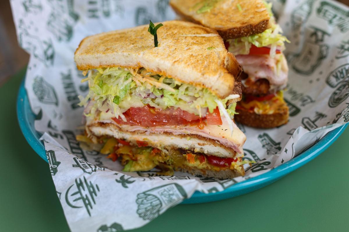 High Street Deli in San Luis Obispo offers a Sando de Oro, which features chicken cutlet, smoked ham, melted herbed mozzarella cheese, chipotle mayo mustard, red onion, pickle, tomato, shredded lettuce, avocado and chilis on toasted sourdough.