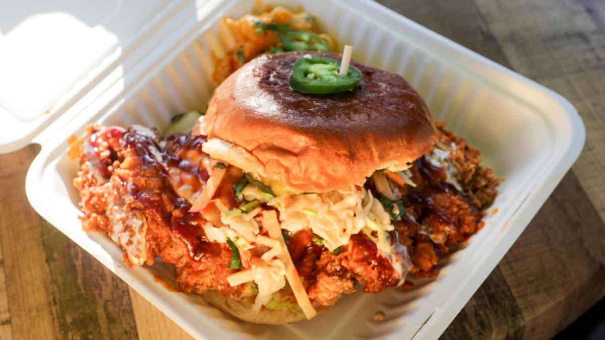 Firebird, fried chicken sandwich, pepper jack, apple slaw, lettuce, tomato, pickles, honey hot sauce, BBQ, ranch. The Grinning Bear food truck specializes in fried chicken.