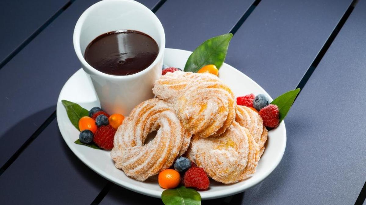 Chonuts — churros in the shape of doughnuts — are served with chocolate dipping sauce at Café Fiero in San Luis Obispo.