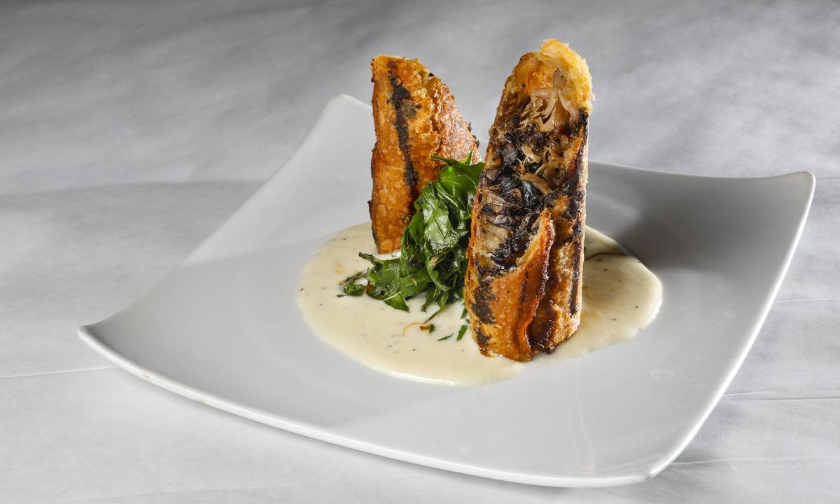 At Park Street Grill, formerly Farmstead Kitchen & Catering, in Paso Robles, duck confit strudel is served with smoky bleu cheese cream, sauteed arugula and cherry gastrique.