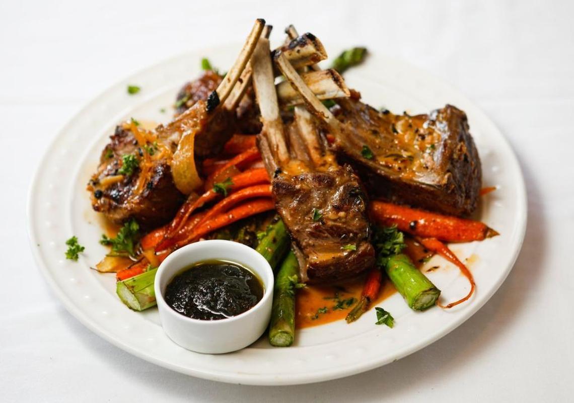 New Zealand rack of lamb is served with caramelized onion marmalade, asparagus and baby organic carrots at Burton House & Grill in Nipomo.