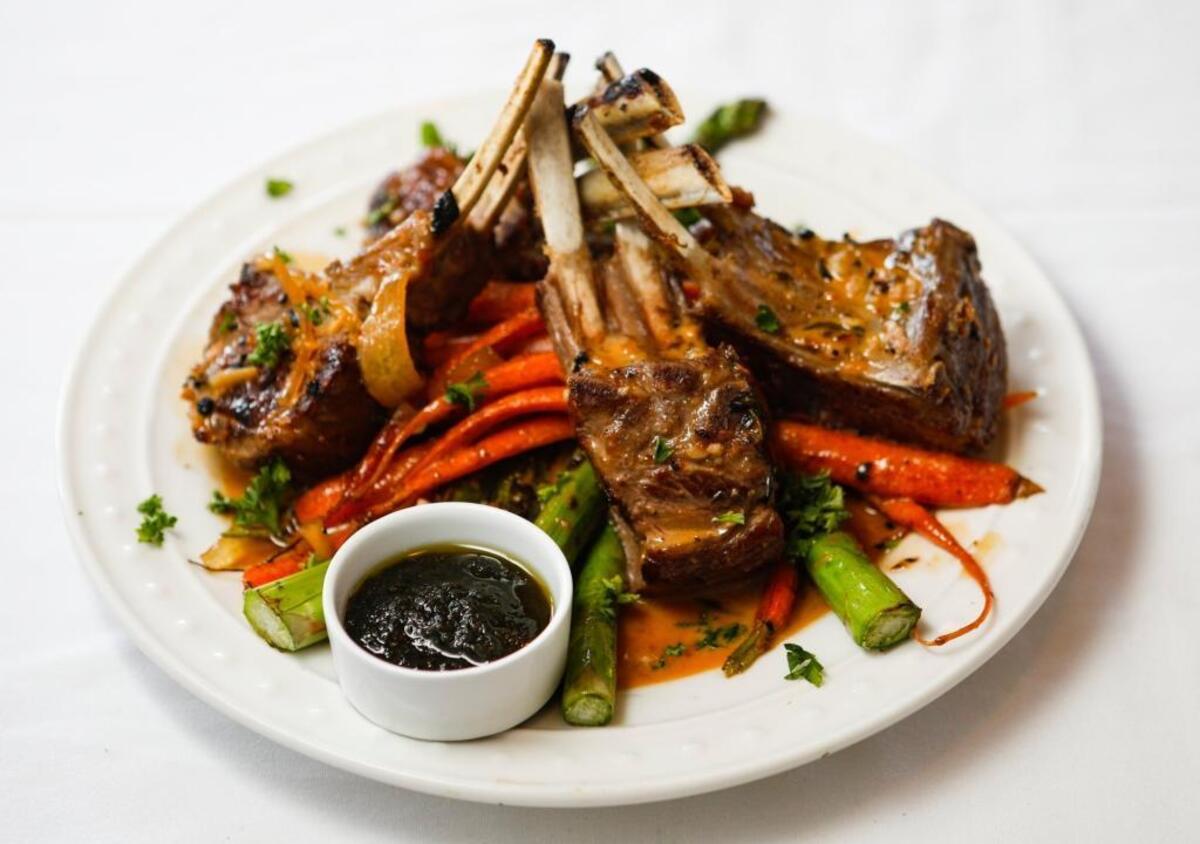New Zealand rack of lamb is served with caramelized onion marmalade, asparagus and baby organic carrots at Burton House & Grill in Nipomo.
