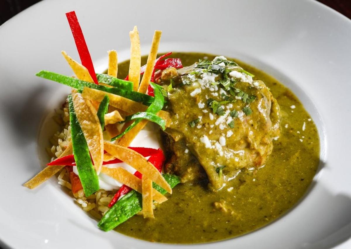 Slow-roasted pork shank is served with chile verde, rice and beans at Blue Moon Southwestern Grill in Paso Robles.